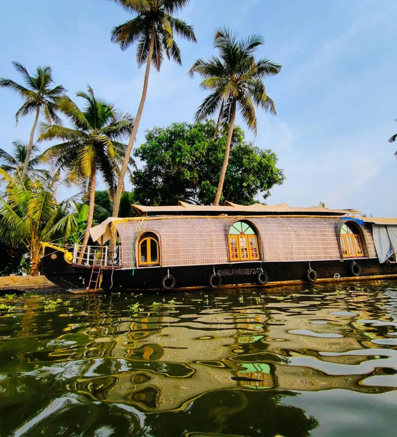 Houseboat at golden hour near Kumarakom — Kerala backwater holiday package